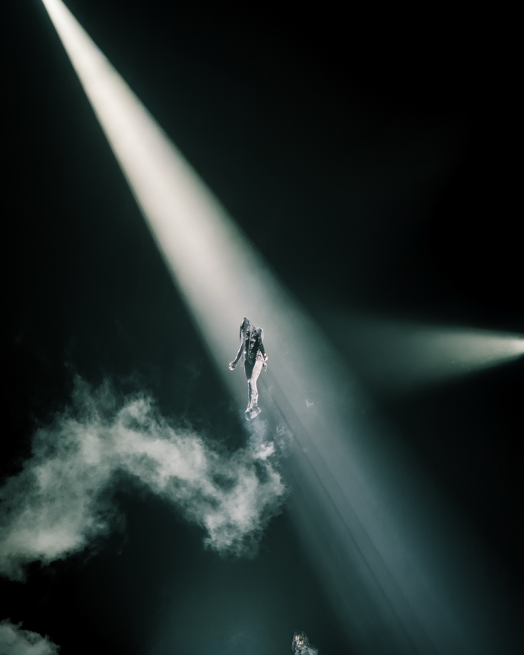 Aerial beam of light on an acrobat above the stage